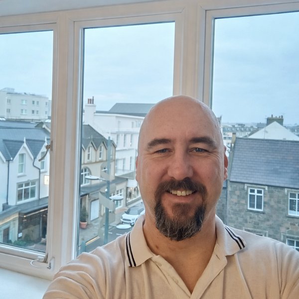 Alastair Swanson – painter and decorator in Portstewart, shown inside a finished client property overlooking the Causeway Coast.